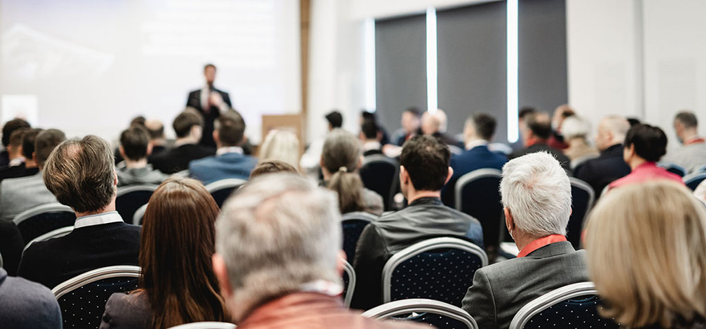 Organizer tips for registration, speaker giving a talk in conference hall