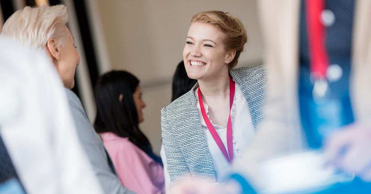 Back to face-to-face trade shows, businesswoman shaking hands at a trade show