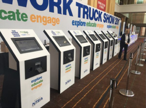 Self-serve contactless check-in kiosks at trade show allowing for quick sign in